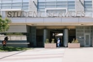 Student walks in front of student services center at East Los Angeles College