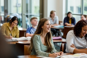 Students take notes in a classroom.