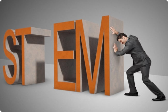 Man pushes the letters EM closer to the letters ST to represent equity and inclusion in STEM