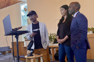 Three individuals stand inside a church during a 24-hour teach-in last week.